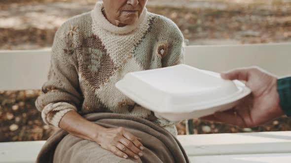 Old Vulnerable Homeless Woman Getting Free Charity Meal