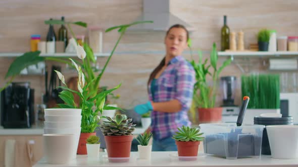 Florist Woman Checking Plants