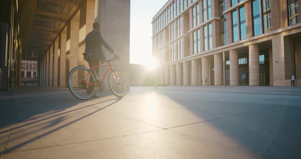 Low Angle View of Mature Businessman in Formal Wear Riding Bicycle Outside