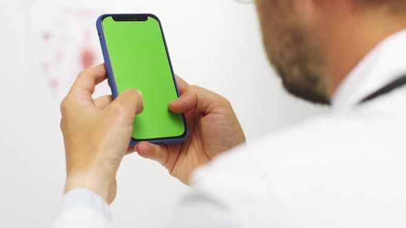 Back View of Doctor Chatting in Chromakey Phone