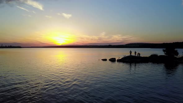 People Enjoying the Riverside Sunset