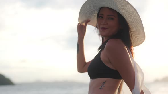 Woman In Sun Hat And Bikini Smiling To Camera