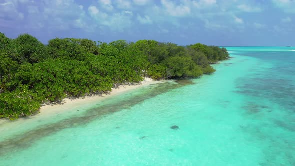 Luxury flying travel shot of a sunshine white sandy paradise beach and aqua blue ocean background 