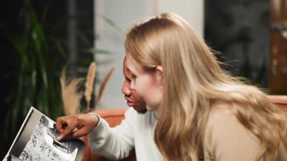 AfricanAmerican Man Shows Faded Photo to Lady Coworker