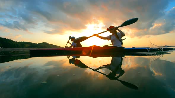 Group of Professional Rowers Are Sailing in the Sunlight