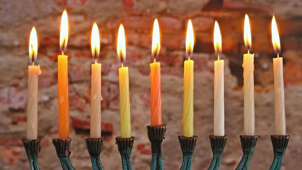 Orthodox Jewish Light a Hanukkah Menorah with Candles