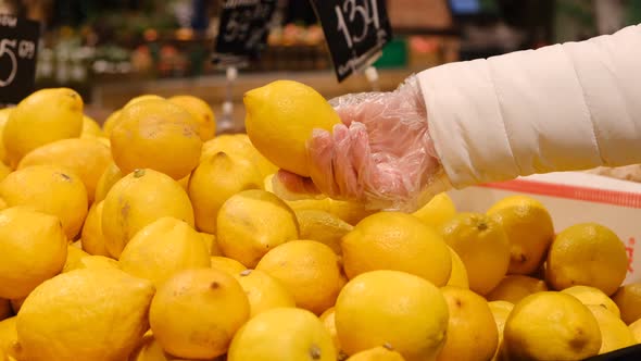 Girl Buys Lemon in the Supermarket Citrus Healthy Food