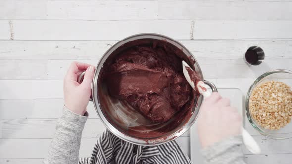 Flat lay. Step by step. Melting chocolate chips in the cooking pot to make macadamia nut fudge