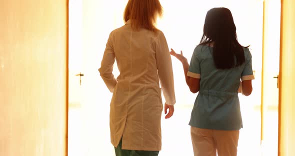 Two Female Doctors Walk Down Hallway and Talk Slow Motion  Movie