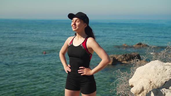 Gorgeous Confident Smiling Woman Standing at Background of Mediterranean Sea Looking Away Smiling