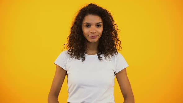 Happy Mixed-Race Female Meditating in Lotus Pose, Practicing Yoga, Health Care