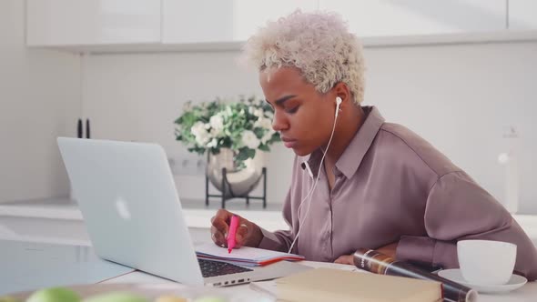 Focused African American Woman Watching Webinar Write Notes Study Online