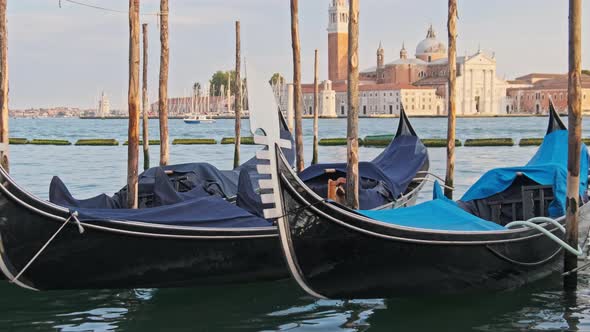 Docked Empty Gondolas on Wooden Mooring Piles Venice Italy