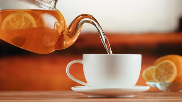 Pouring Citrus Black Tea Into Cup Closeup