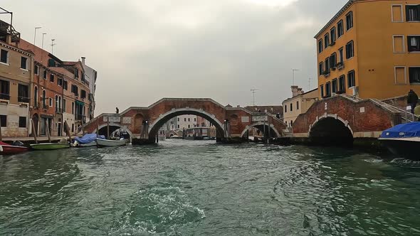 Ponte dei Tre Archi bridge in Cannaregio seen from sailing boat on canal, Venice in Italy