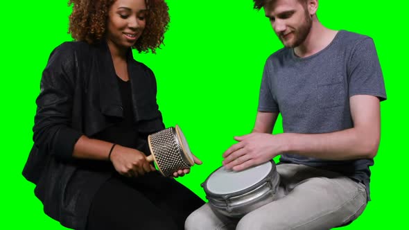 Happy musicians playing cabasa and drum
