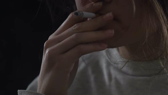 Miserable Woman Eagerly Smoking Cigarette, Thinking About Her Poor Life, Closeup