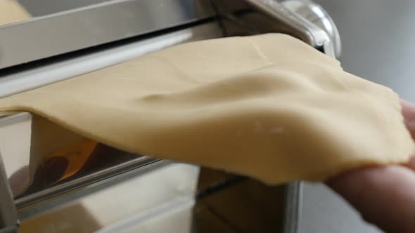 Processing  dough at home for Italian lasagna 4K 2160p 30fps UltraHD footage - Kitchen pasta machine