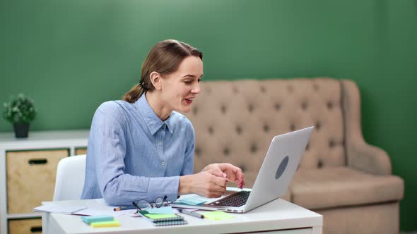 Happy Business Woman Looking at Laptop Celebrating Successful Deal