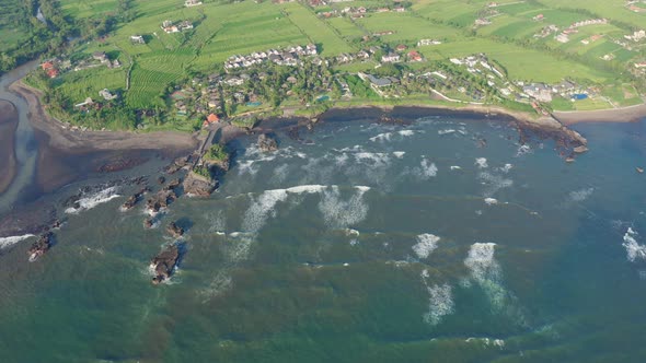 Aerial Footage of Black Volcanic Beach Green Rice Terraces