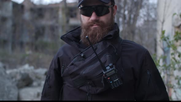 Closeup of Seriouslooking Bodyguard in Black Clothes and Sunglasses Safeguard Area