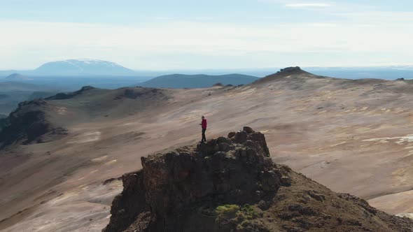 Photographer Man Traveler on Mountain Top Taking Pictures. Iceland. Aerial View