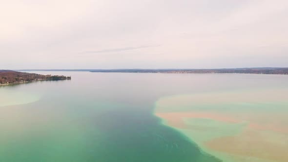 Drone shot of Torch Lake, Michigan. Panning left motion