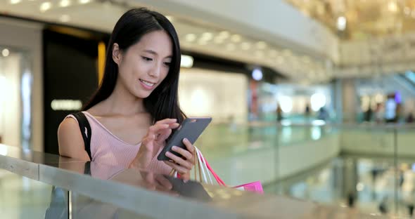 Woman use of mobile phone in shopping mall 