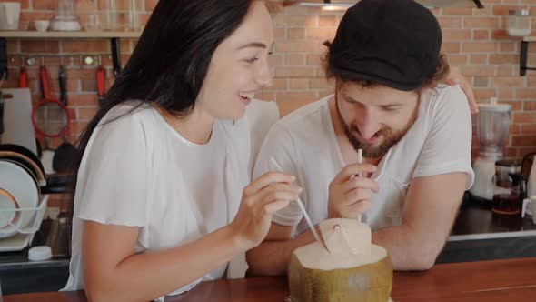 Close Up of Young Couple Enjoying Their Time Drinking a Fresh Coconut