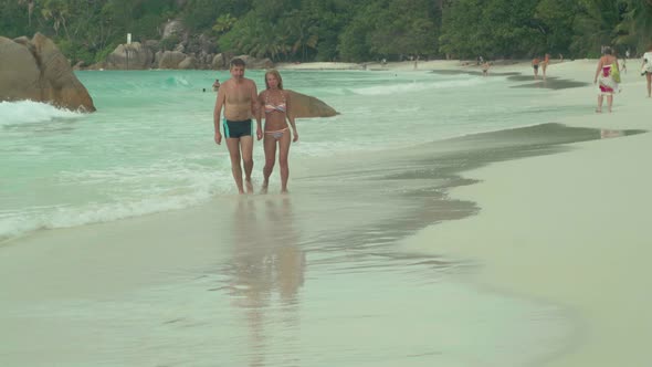 Beautiful Happy Couple in Love Resting on the Beach on Island