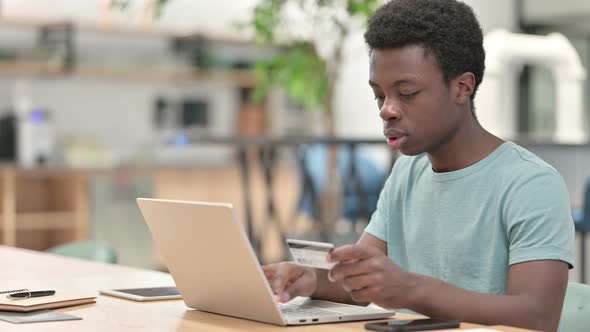 Successful Online Shopping on Laptop By Young African Man