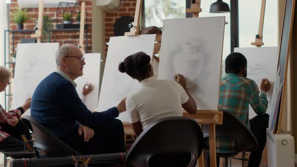 Senior Student Talking to Young Woman About Drawing Lesson