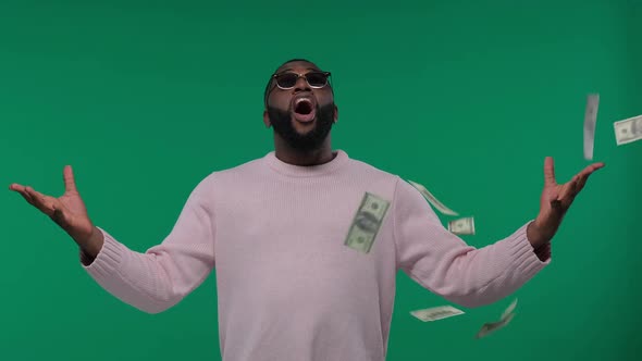 Happy AfricanAmerican Man Throwing Dollars Banknotes Wasting Money on Green Screen Chroma Key