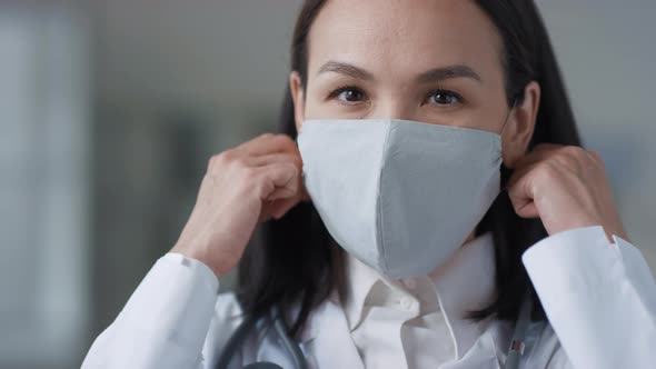 Asian Doctor Taking Off Mask