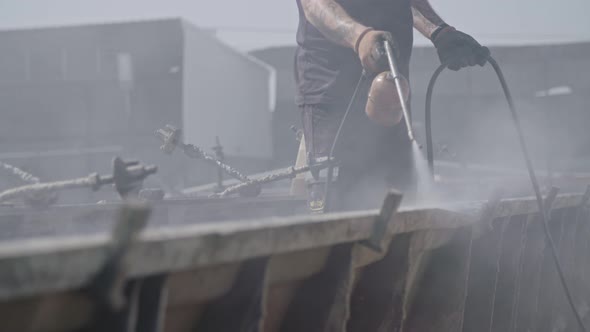 Construction workers cleaning steel concrete molds