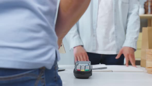 Close up hands of young man use mobile phone pay for vase goods order.