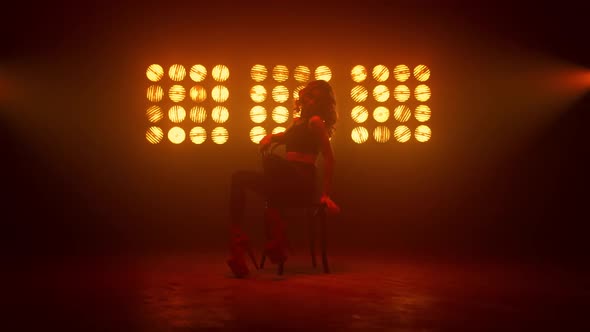 Dancer Girl Practicing Streaptease Elements on Chair