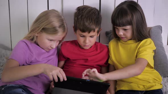 Modern Children, Little Boy with Girls Slide Their Finger on Touch Screen of Tablet Computer