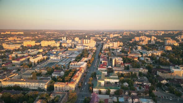 Aerial drone view of Chisinau downtown at sunset. Panorama view of multiple buildings, roads with mo