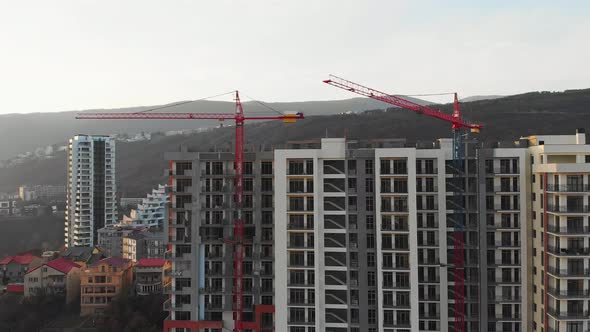 Crane Moving Above House Consctruction Site