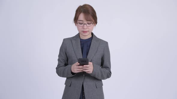 Young Happy Asian Businesswoman Using Phone