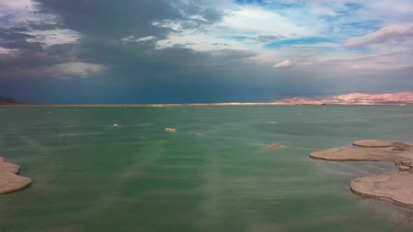 the Camera Flies Over the Dead Sea Against the Backdrop of a Beautiful Cloudy Sky
