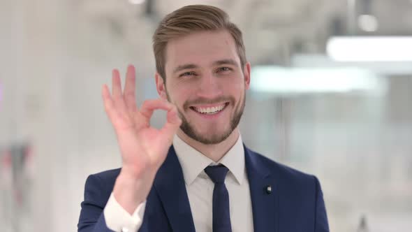 Young Businessman Showing Okay Sign with Hand