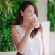 Attractive Asian woman drinking milk and smiling at home close up face.healthy - VideoHive Item for Sale