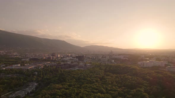 Aerial View of Living Buildings and City Park in Sofia with Sunset Horizon