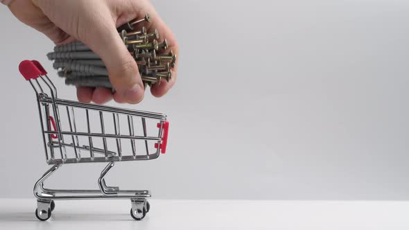 a Basket From a Supermarket is Rolled Out and a Lot of Screws are Put in It