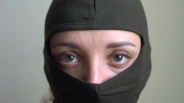 Female Portrait of Young Girl Wearing Khaki Balaclava Only Eyes are Visible Mandatory Conscription
