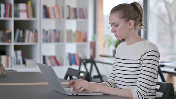 Laptop Use By Professional Young Woman in Library 