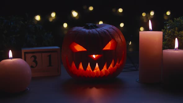 Smiling Halloween Pumpkin on the Wooden Table in a Mystic Night