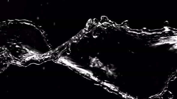 Super Slow Motion Shot of Swirling and Splashing Water Isolated on Black Background at 1000Fps